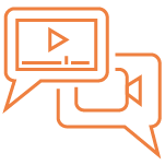 A row of computer monitors displaying various surveillance camera feeds, with a telephone and keyboard in the foreground.